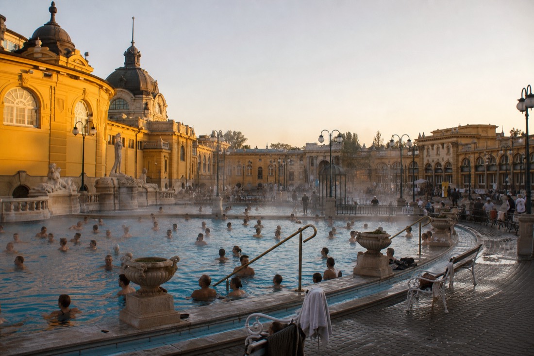Grand historic bath courtyard contrasted with a calm local thermal pool in Budapest