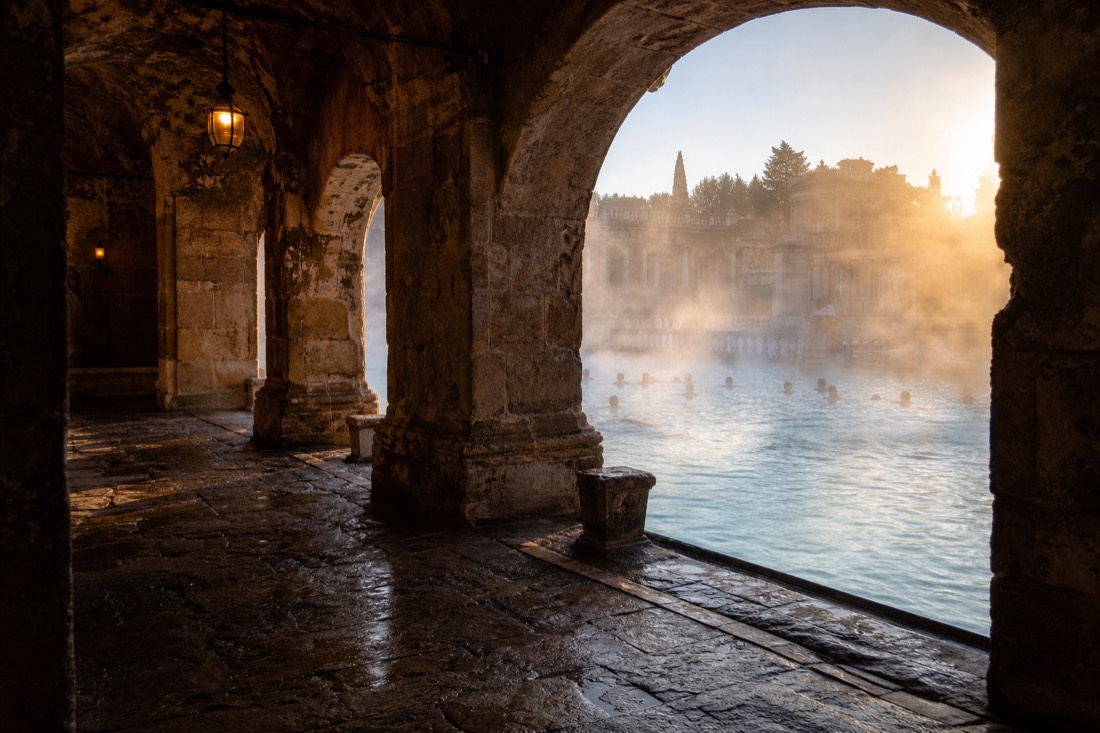 Contrast of a historic domed bath interior and a grand outdoor pool in Budapest